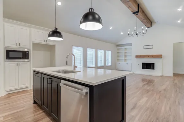 a kitchen with sink cabinets and wooden floor