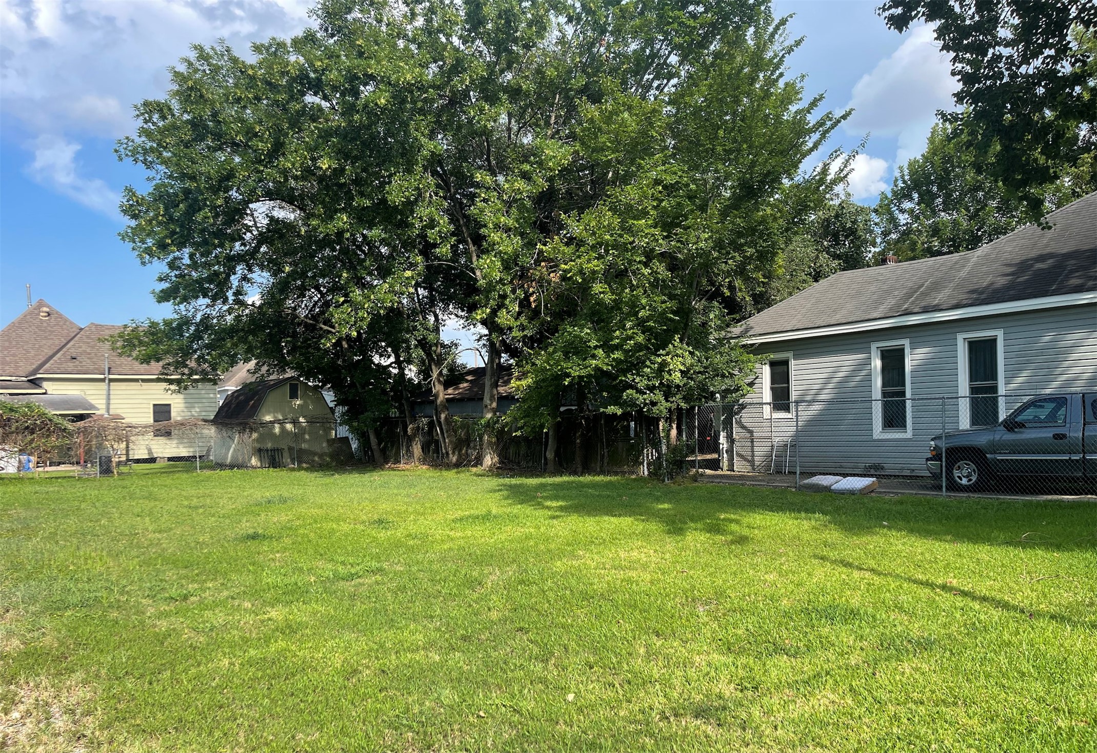 2114 Chestnut Street Houston, TX 77009 - Photo 4 of 8 a view of a house with a big yard and large trees