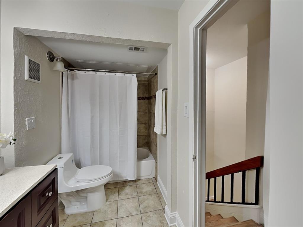 4220 Madera Road Irving, TX 75038 - Photo 16 of 22 Bathroom with shower / bath combo, visible vents, vanity, and toilet