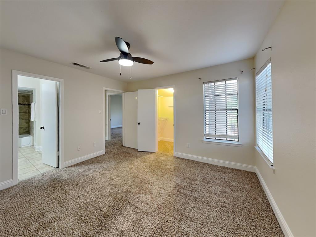 4220 Madera Road Irving, TX 75038 - Photo 17 of 22 Unfurnished bedroom featuring light colored carpet, a spacious closet, baseboards, and visible vents