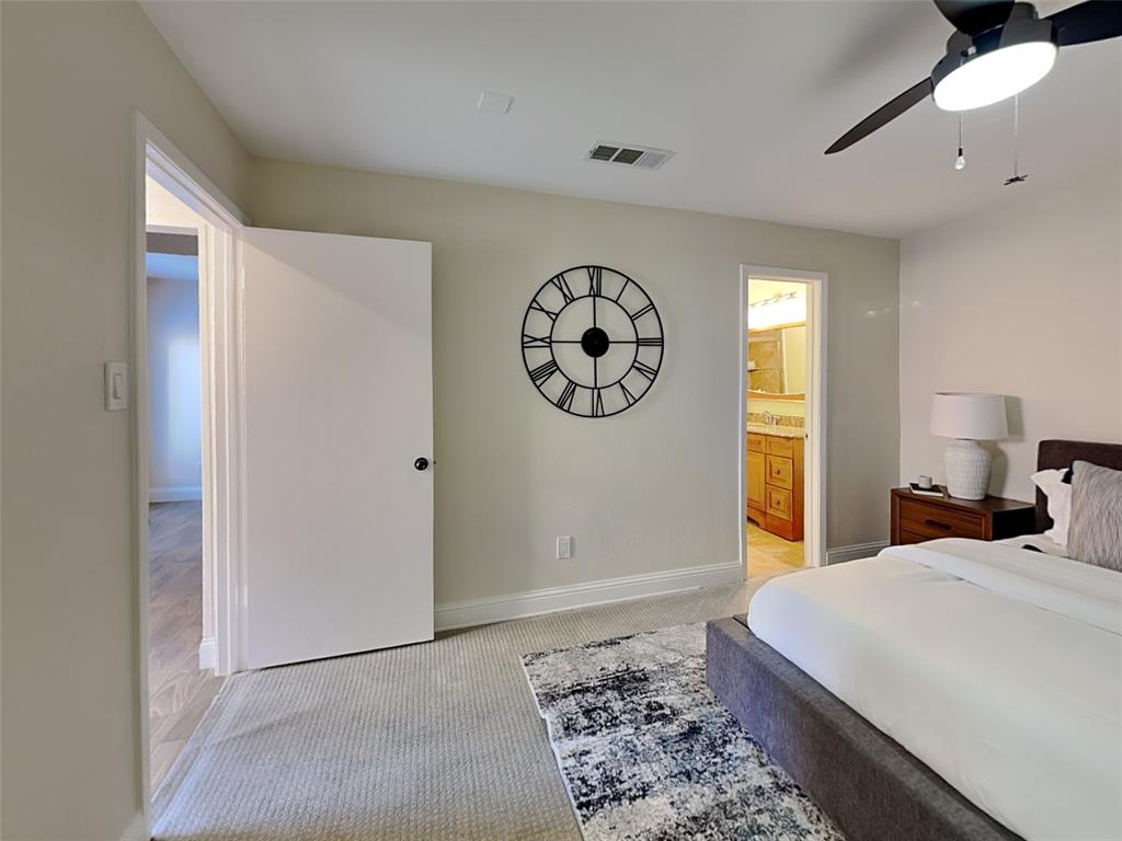4220 Madera Road Irving, TX 75038 - Photo 5 of 22 Bedroom with a ceiling fan, connected bathroom, light carpet, baseboards, and visible vents