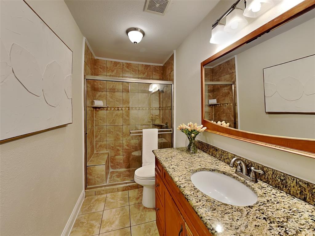 4220 Madera Road Irving, TX 75038 - Photo 7 of 22 Full bathroom featuring tile patterned flooring, visible vents, toilet, vanity, and a stall shower