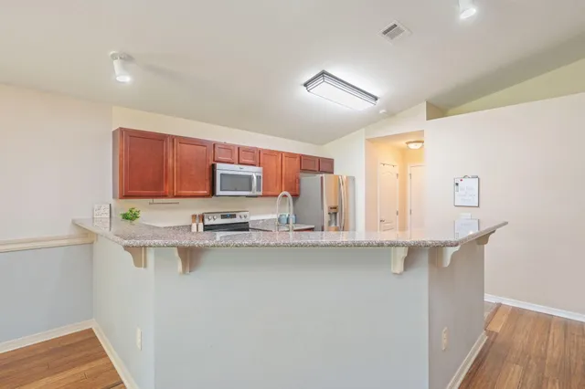a kitchen with stainless steel appliances a sink and cabinets