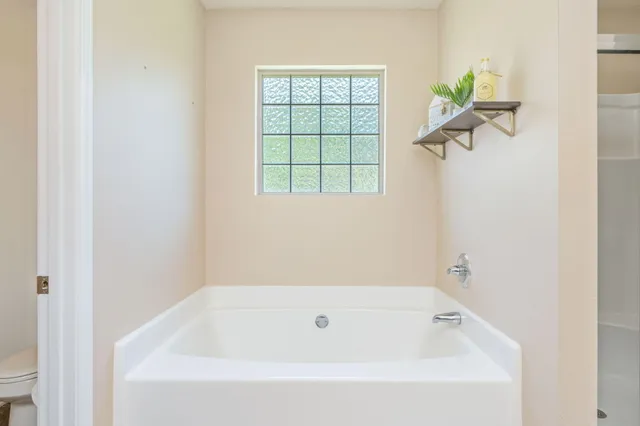 a white bath tub with a window