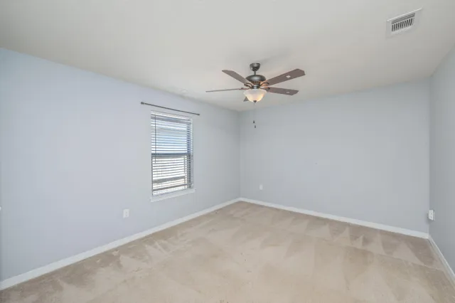 a view of a room with a ceiling fan