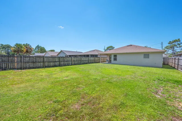 a view of yard with swimming pool and green space