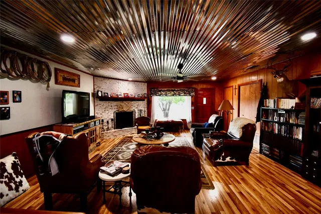 a living room with furniture a flat screen tv and outdoor seating