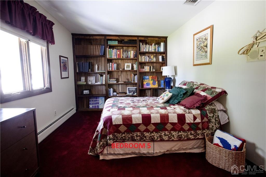 37 Runnymede Road Colonia, NJ 07067 - Photo 16 of 33 a bedroom with a bed and a book shelf
