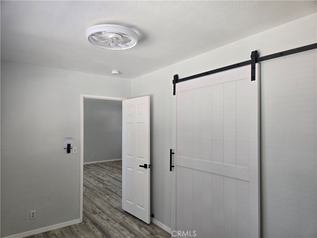 765 Iris Drive, Unit 2 Big Bear Lake, CA 92315 - Photo 3 of 7 a view of a hallway with wooden floor
