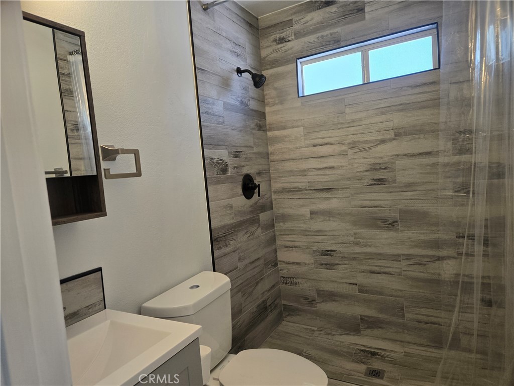 765 Iris Drive, Unit 2 Big Bear Lake, CA 92315 - Photo 5 of 7 a bathroom with a toilet and a shower