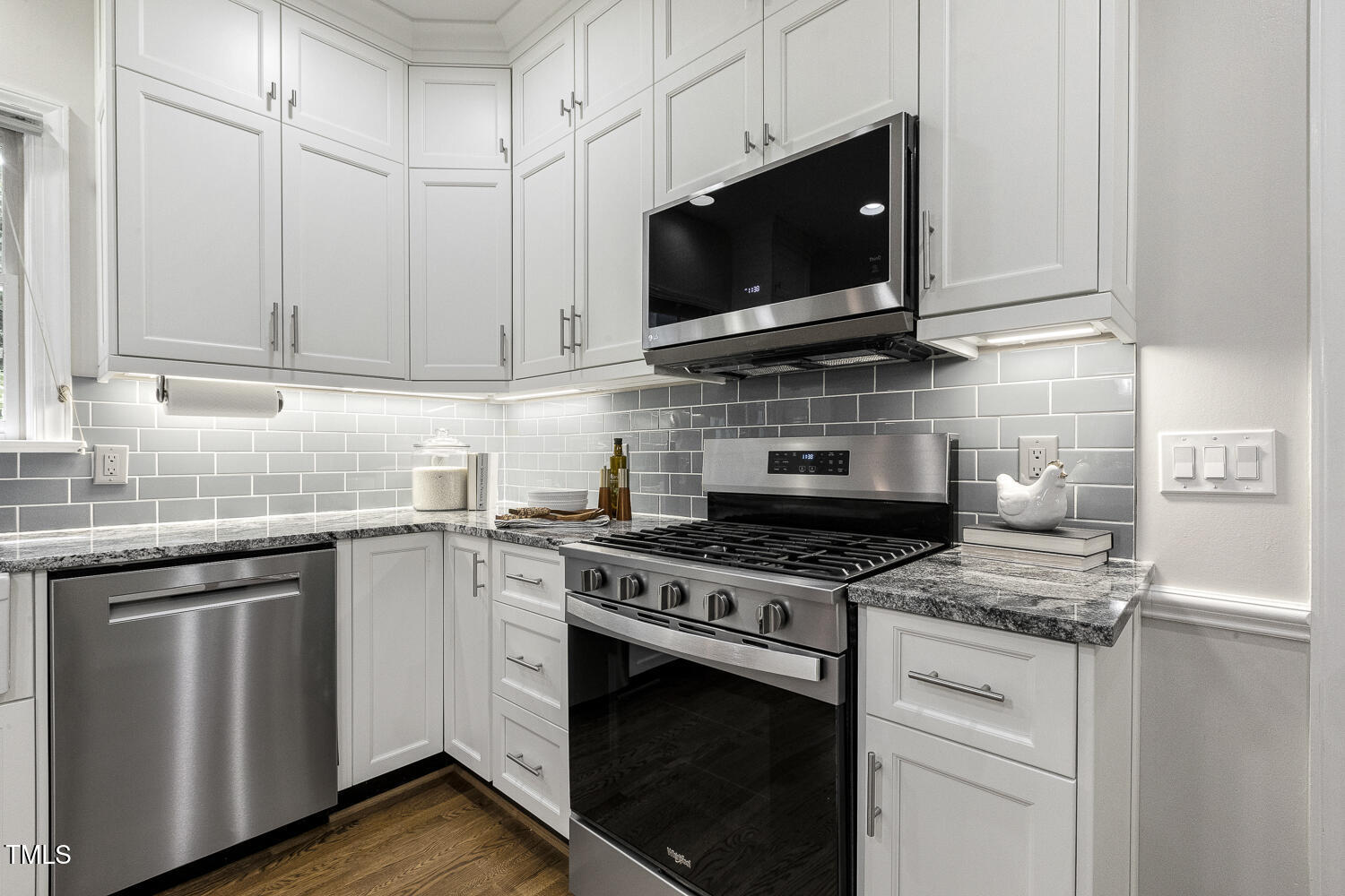 110 Felspar Way Cary, NC 27518 - Photo 14 of 71 a kitchen with stainless steel appliances granite countertop a stove a sink and a microwave