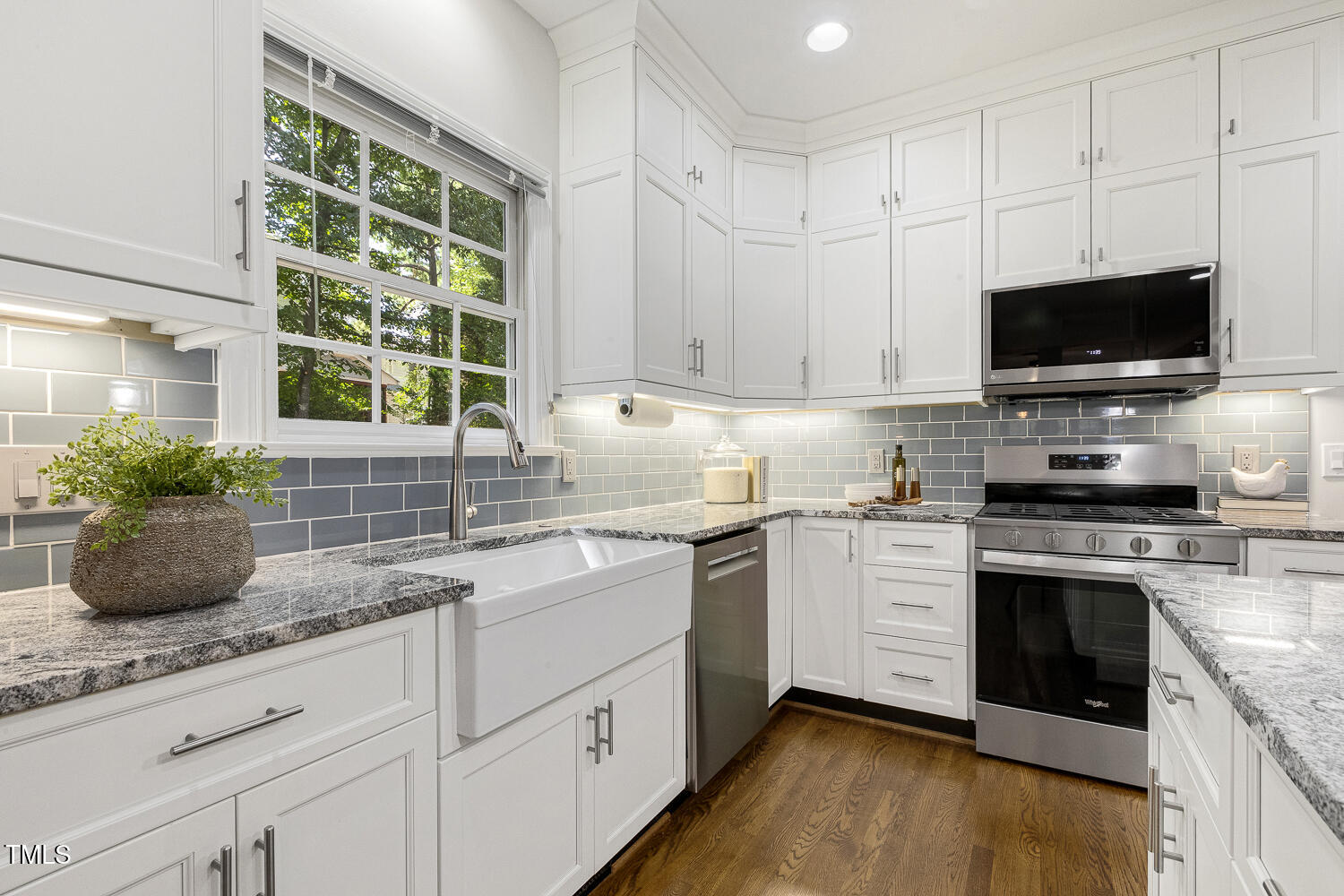 110 Felspar Way Cary, NC 27518 - Photo 15 of 71 a kitchen with granite countertop a sink stainless steel appliances and cabinets