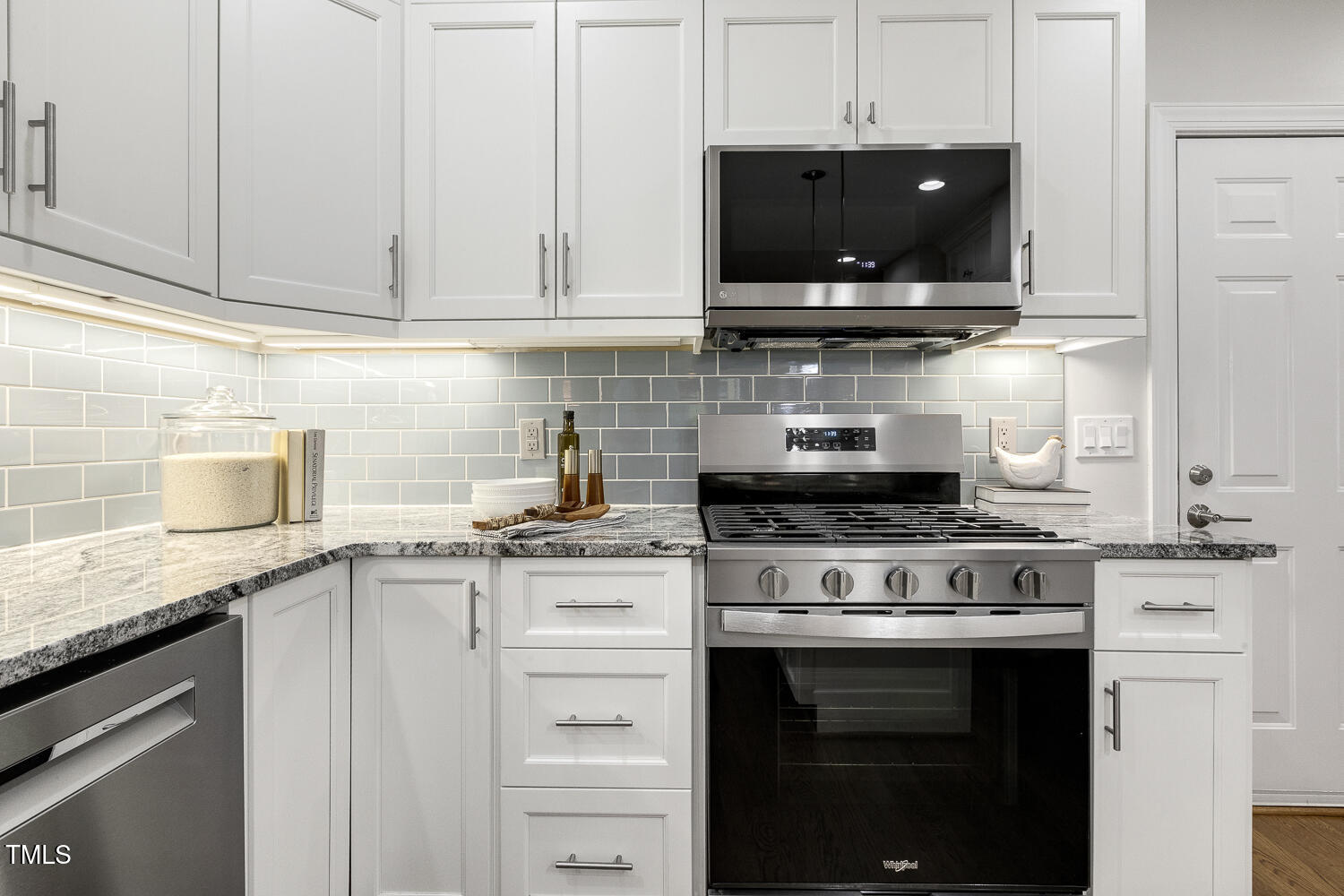 110 Felspar Way Cary, NC 27518 - Photo 17 of 71 a kitchen with stainless steel appliances granite countertop a stove a sink and a white cabinets