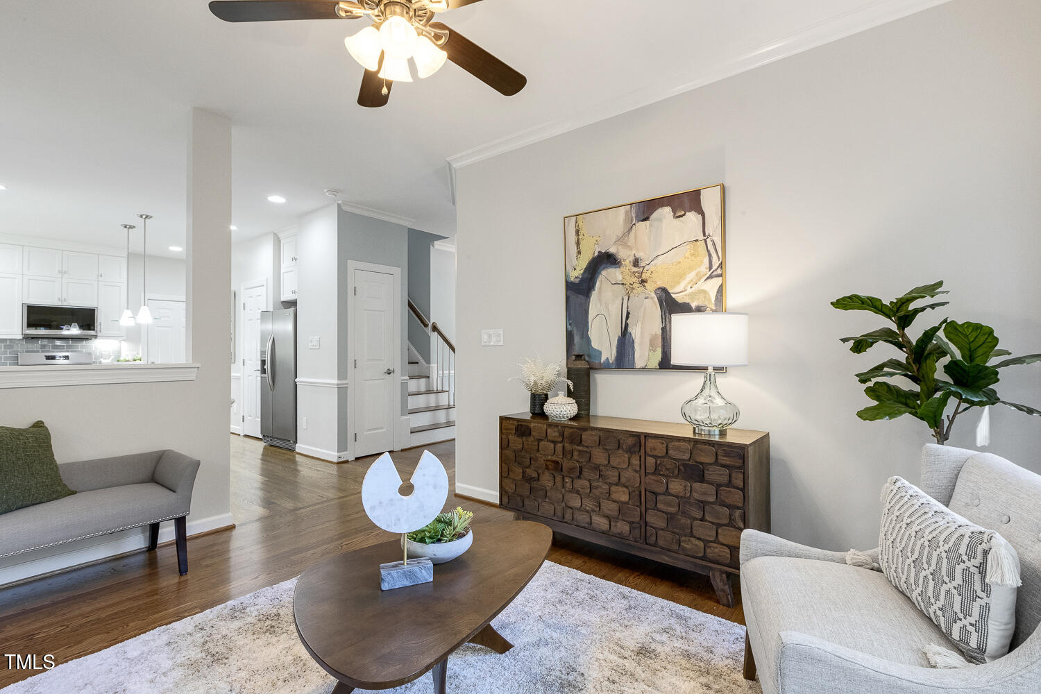 110 Felspar Way Cary, NC 27518 - Photo 24 of 71 a living room with furniture a chandelier and a rug