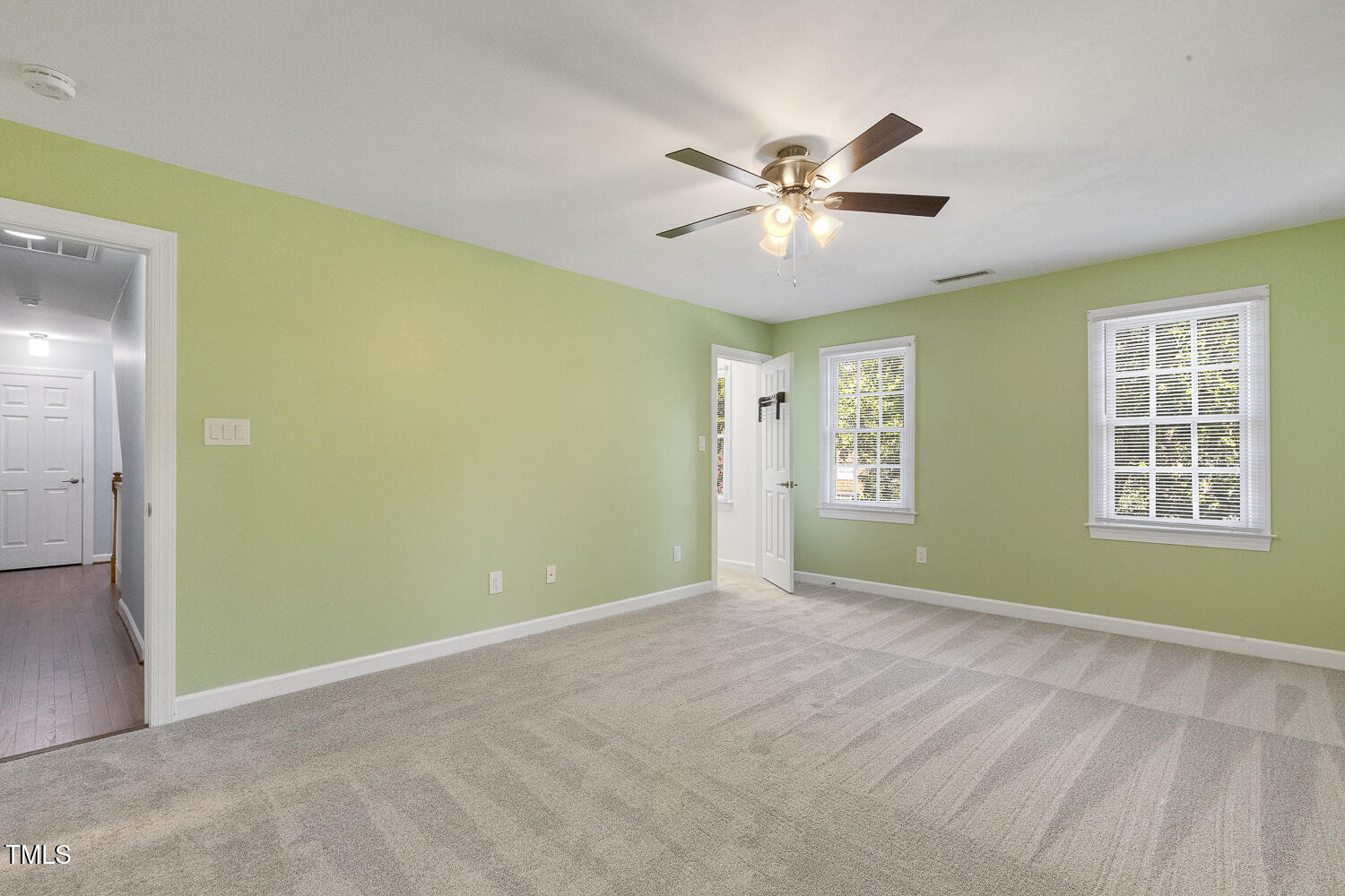 110 Felspar Way Cary, NC 27518 - Photo 27 of 71 a view of an empty room with chandelier fan and a window