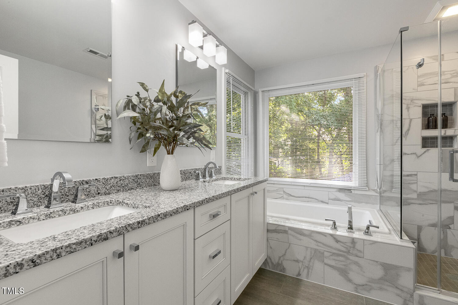 110 Felspar Way Cary, NC 27518 - Photo 32 of 71 a bathroom with a granite countertop sink mirror and a bathtub