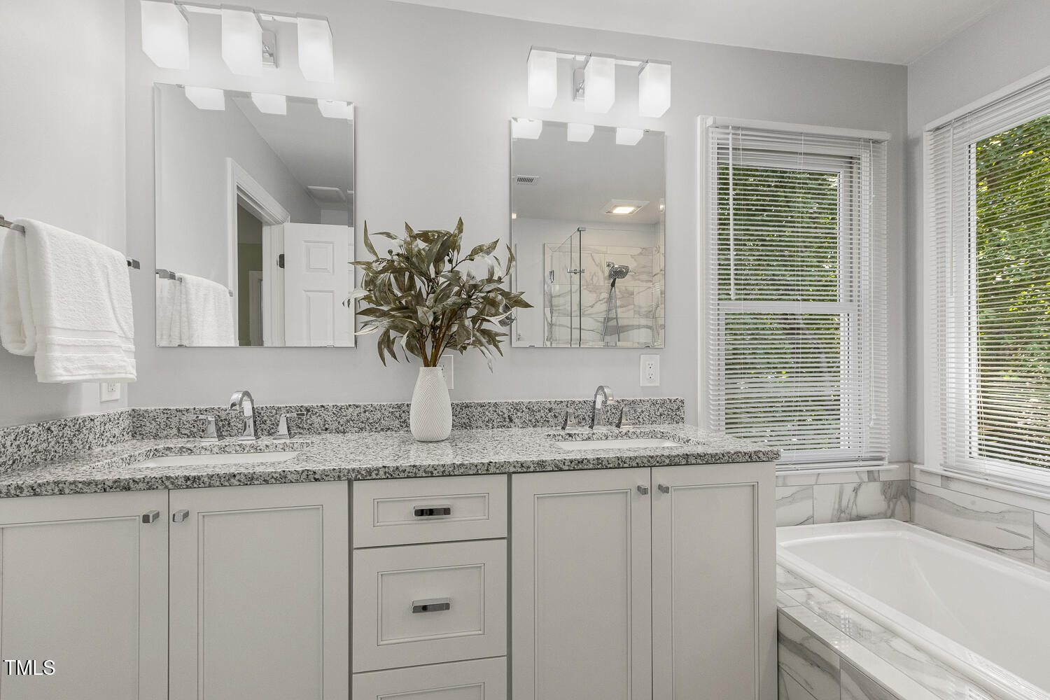 110 Felspar Way Cary, NC 27518 - Photo 33 of 71 a bathroom with a granite countertop sink mirror and a bathtub