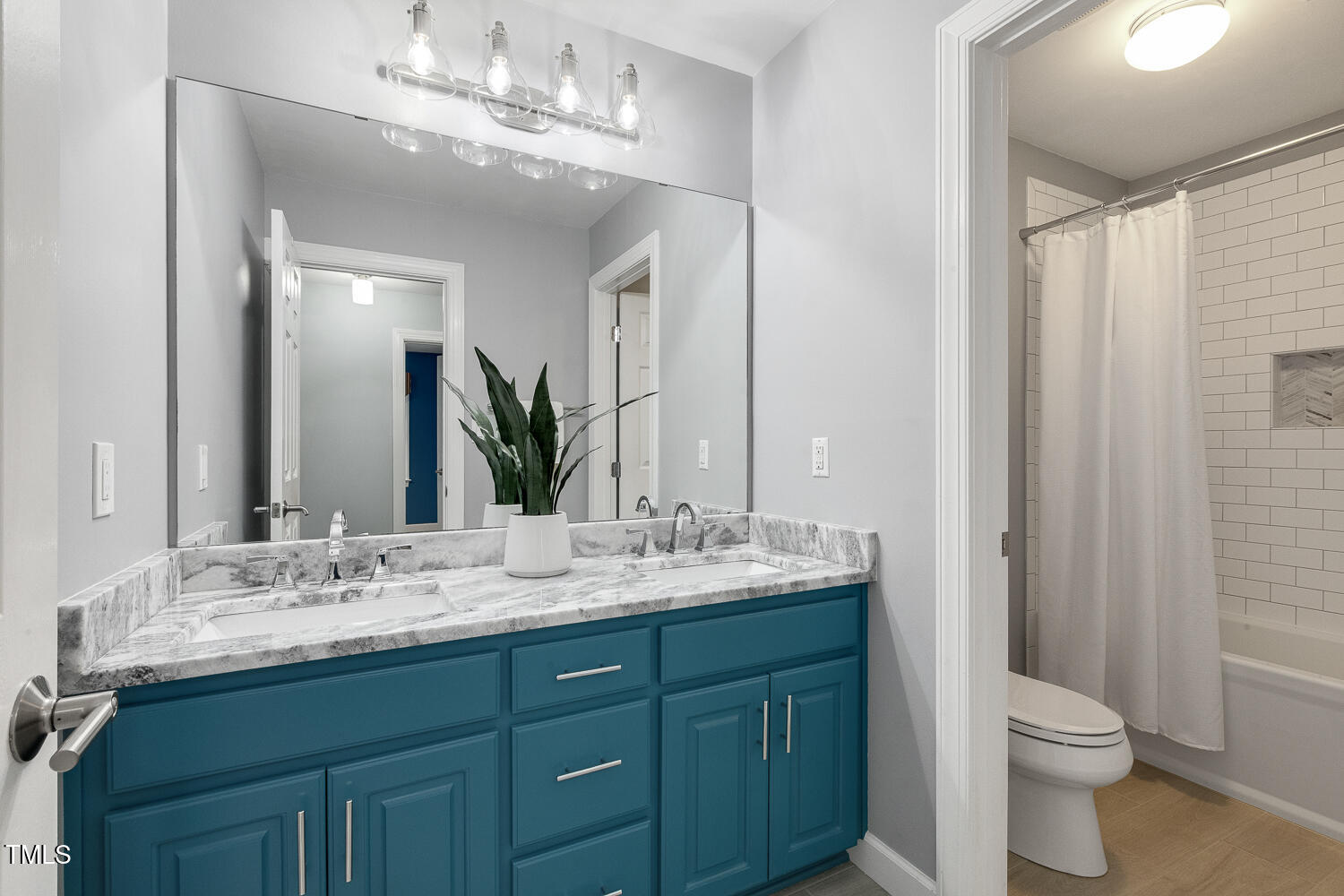 110 Felspar Way Cary, NC 27518 - Photo 37 of 71 a bathroom with a double vanity sink and a mirror