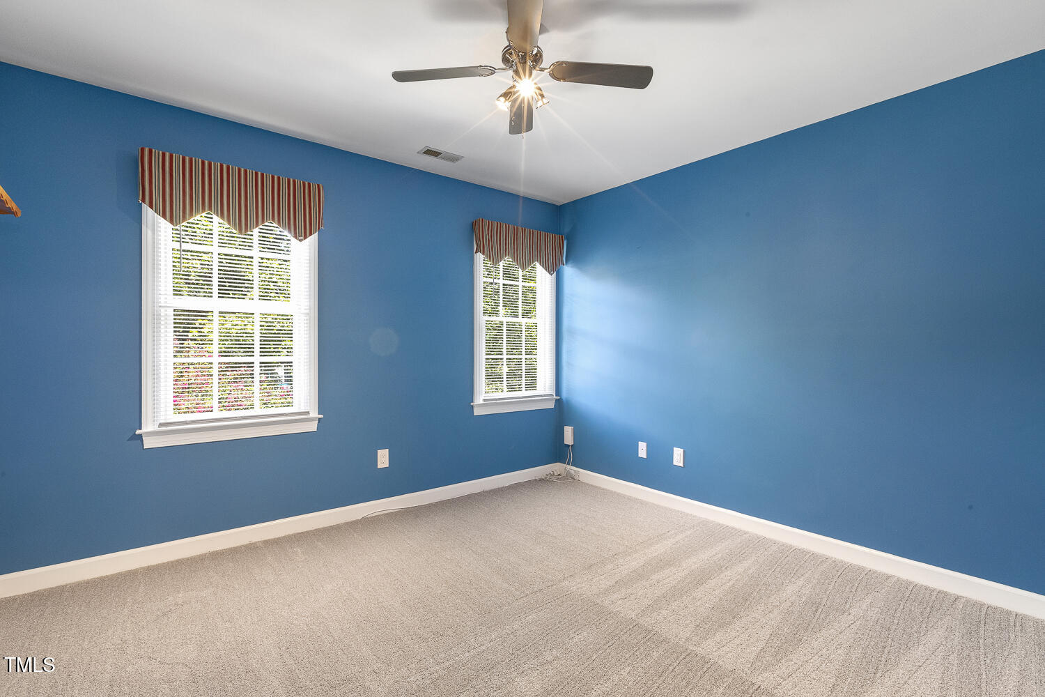 110 Felspar Way Cary, NC 27518 - Photo 38 of 71 a view of empty room with windows and chandelier fan