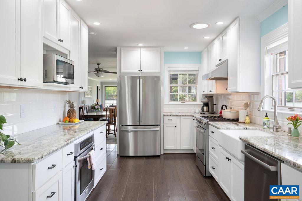 25 Bolling Circle Palmyra, VA 22963 - Photo 13 of 45 a kitchen with stainless steel appliances granite countertop a refrigerator a stove a sink dishwasher and white cabinets with wooden floor