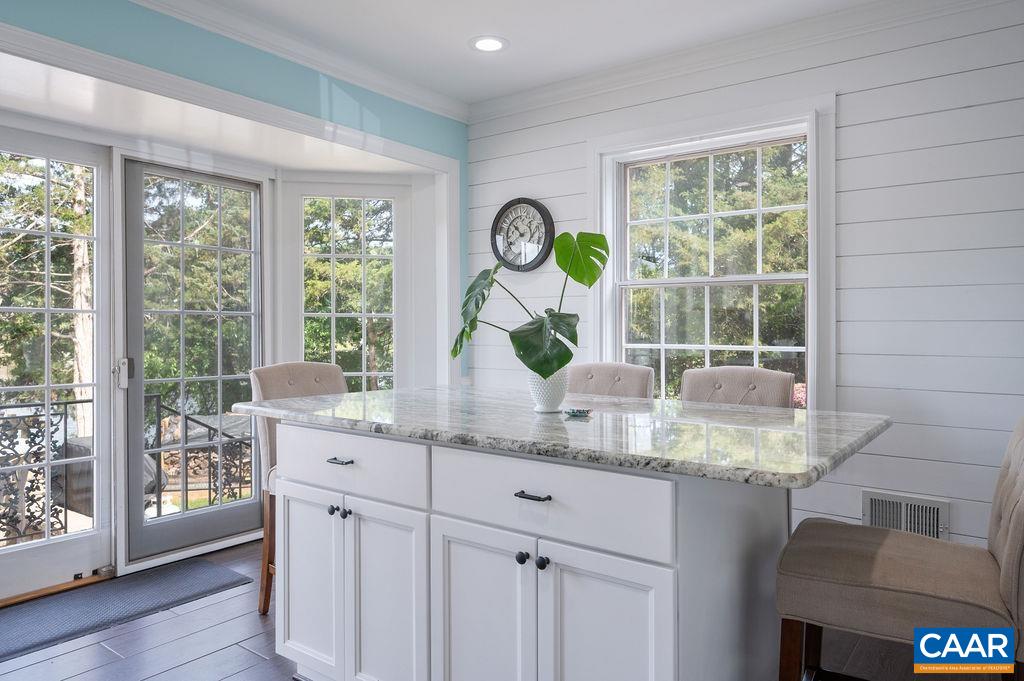 25 Bolling Circle Palmyra, VA 22963 - Photo 14 of 45 a kitchen with kitchen island granite countertop a large window a sink and white cabinets