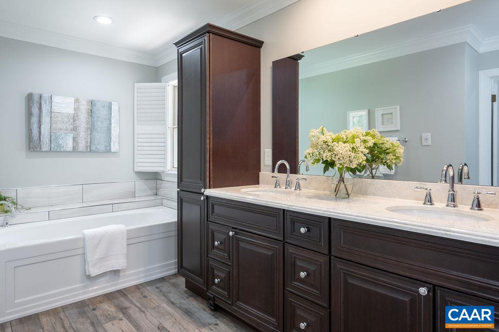 25 Bolling Circle Palmyra, VA 22963 - Photo 20 of 45 a bathroom with a double vanity sink and a bathtub