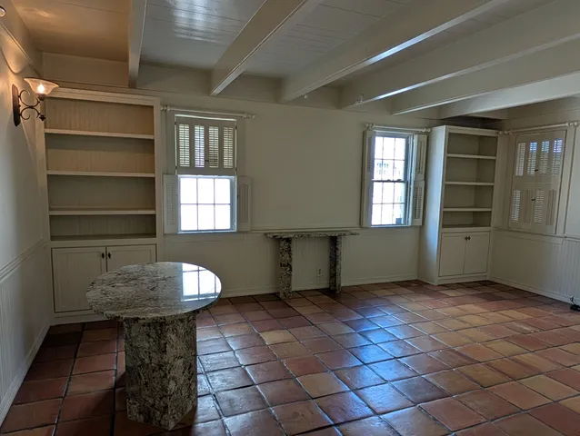 a view of empty room with window and fireplace