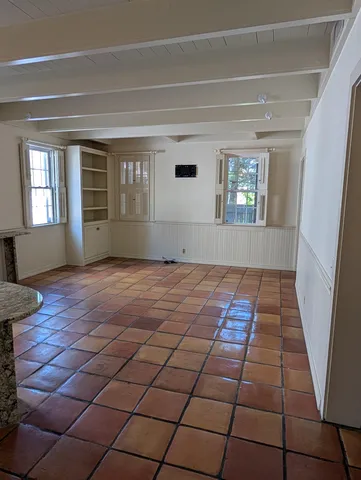 a kitchen with stainless steel appliances a sink cabinets and a window