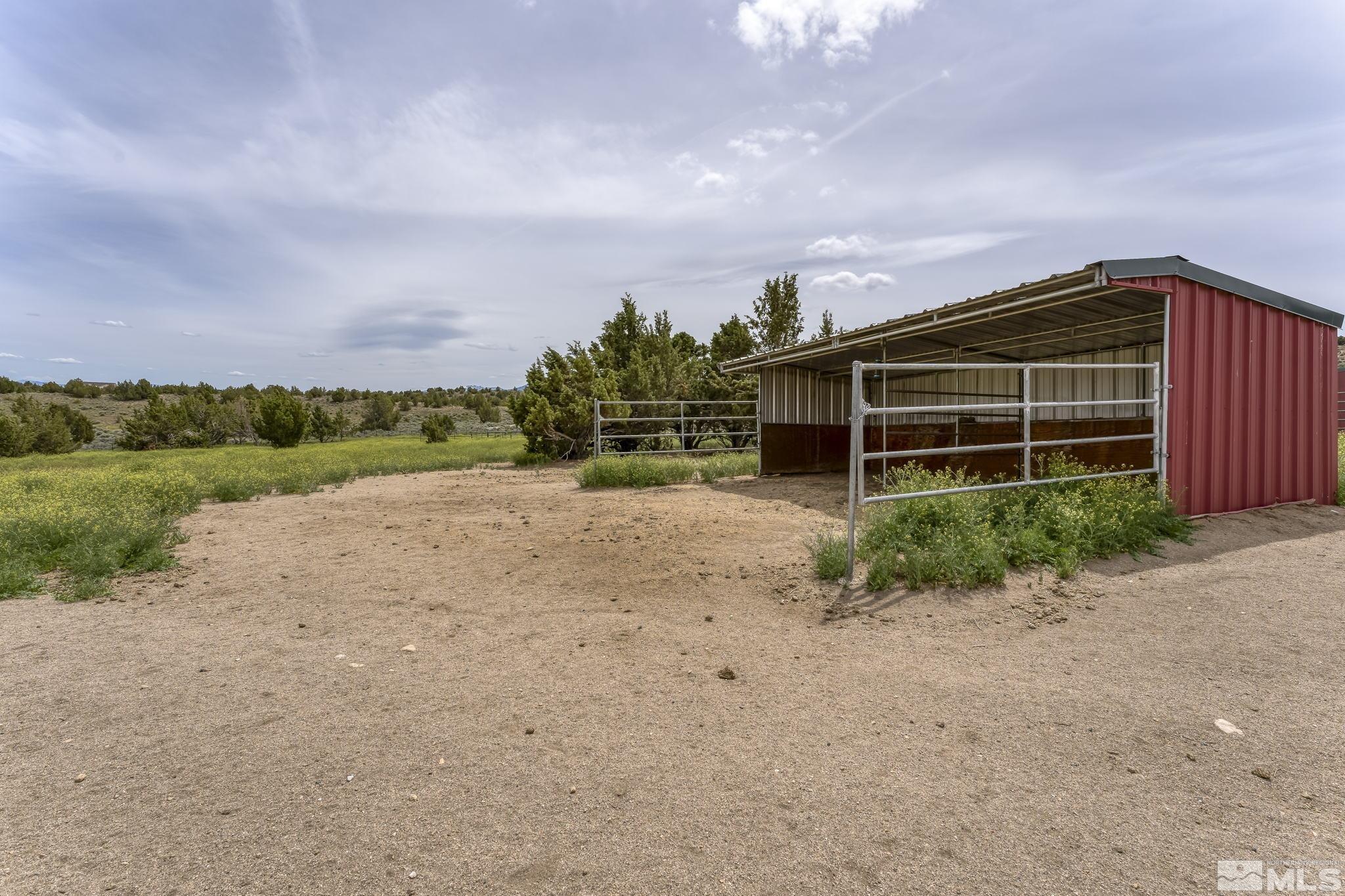 1220 Argosy Road Reno, NV 89508 - Photo 32 of 40 a backyard of a house with a yard and garage