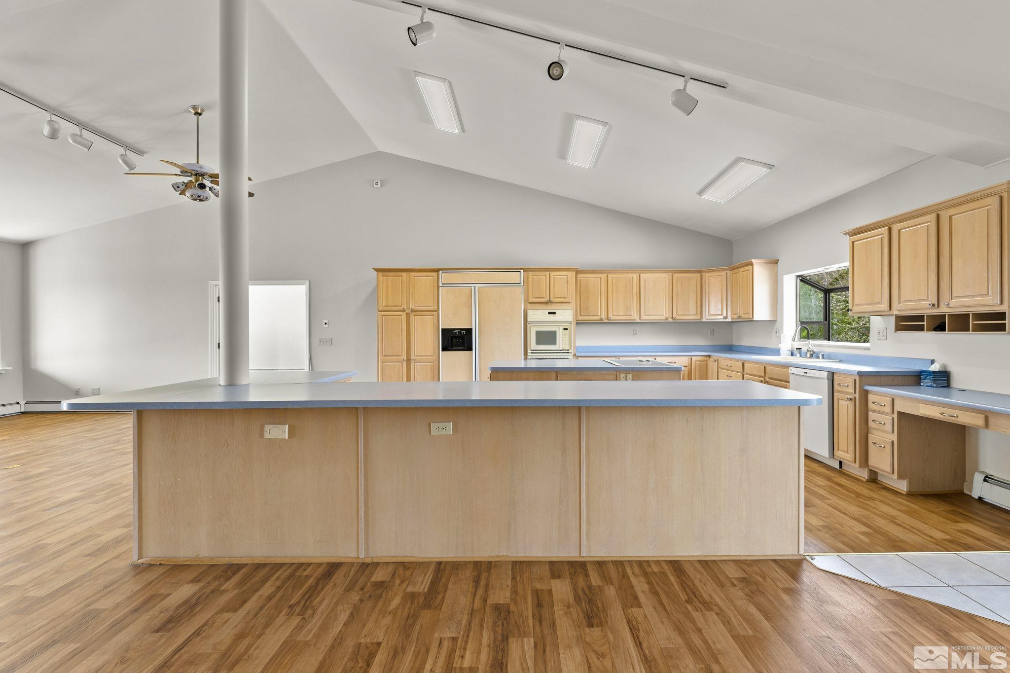 1220 Argosy Road Reno, NV 89508 - Photo 8 of 40 a large kitchen with cabinets wooden floor and stainless steel appliances