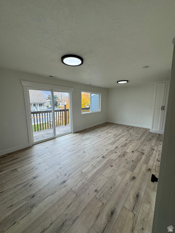 608 South 500 West, Unit 3 Provo, UT 84601 - Photo 5 of 35 Spacious room with wood-finish flooring, recessed lighting, and a glass sliding door leading to a balcony