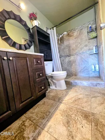 a view of a bathroom with a sink and a mirror
