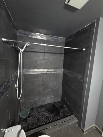 a bathroom with a glass shower door