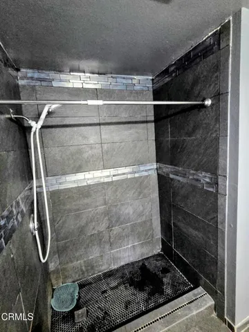a bathroom with a glass shower door