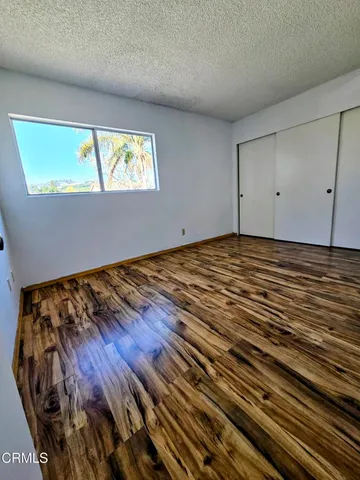a view of a room with wooden floor