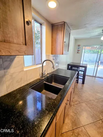 a kitchen with granite countertop a sink and a stove