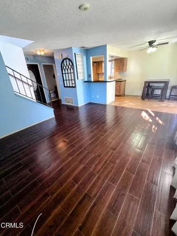 a view of empty room with wooden floor