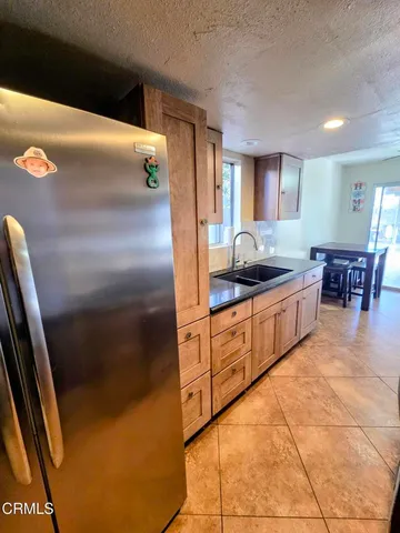 a kitchen with stainless steel appliances granite countertop a refrigerator and a stove