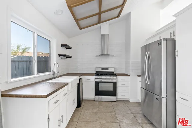 a kitchen with a stove sink and refrigerator