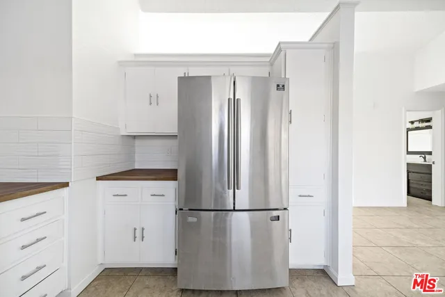 a white refrigerator freezer sitting in a kitchen