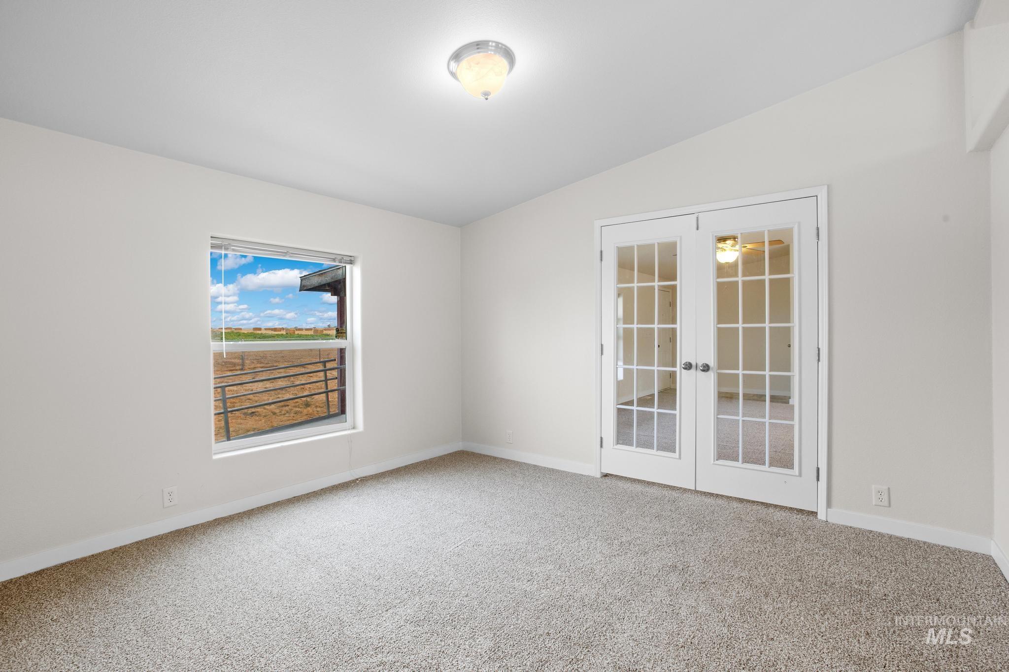15190 Oasis Road Caldwell, ID 83607 - Photo 17 of 36 White walls with neutral carpeting