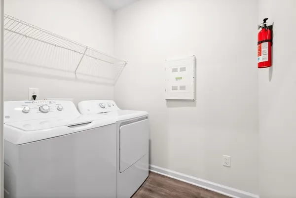 an empty room with windows and chandelier fan
