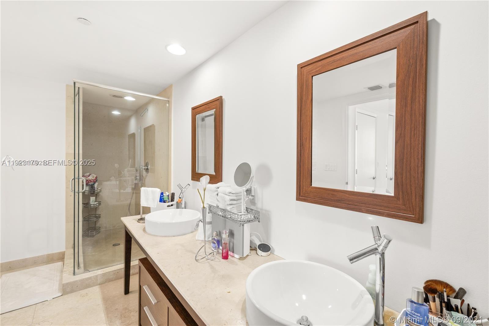 495 Brickell Avenue, Unit 1002 Miami, FL 33131 - Photo 3 of 8 a bathroom with a double vanity sink and a mirror