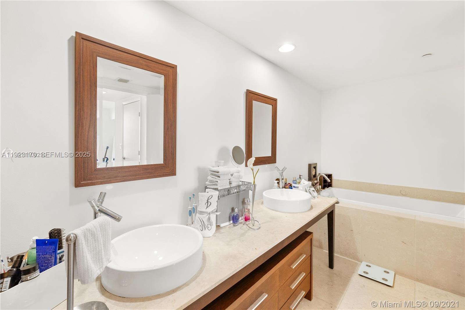 495 Brickell Avenue, Unit 1002 Miami, FL 33131 - Photo 4 of 8 a bathroom with a sink and a mirror