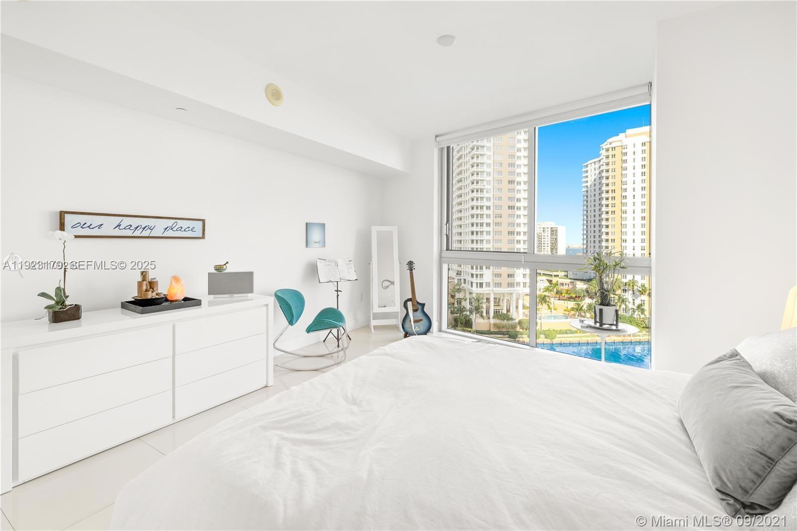 495 Brickell Avenue, Unit 1002 Miami, FL 33131 - Photo 5 of 8 a bedroom with a bed and a large window