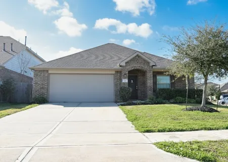 a front view of a house with yard and green space
