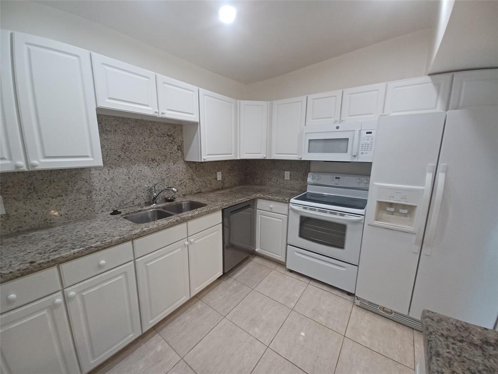 301 North Pine Island Road, Unit 216 Plantation, FL 33324 - Photo 5 of 14 a kitchen with white cabinets stainless steel appliances and sink