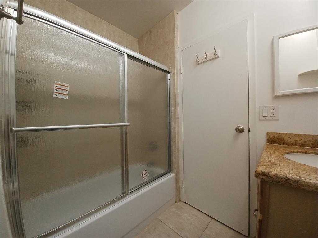 301 North Pine Island Road, Unit 216 Plantation, FL 33324 - Photo 8 of 14 a bathroom with a granite countertop sink mirror and shower