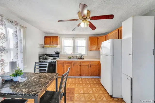 a kitchen with stainless steel appliances granite countertop a refrigerator and a stove top oven
