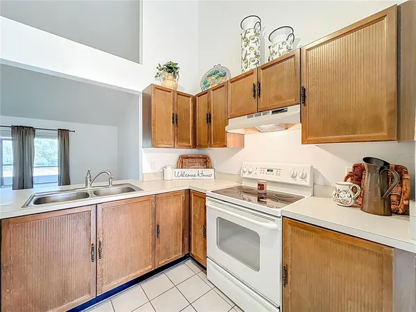 a kitchen with cabinets a sink and white appliances